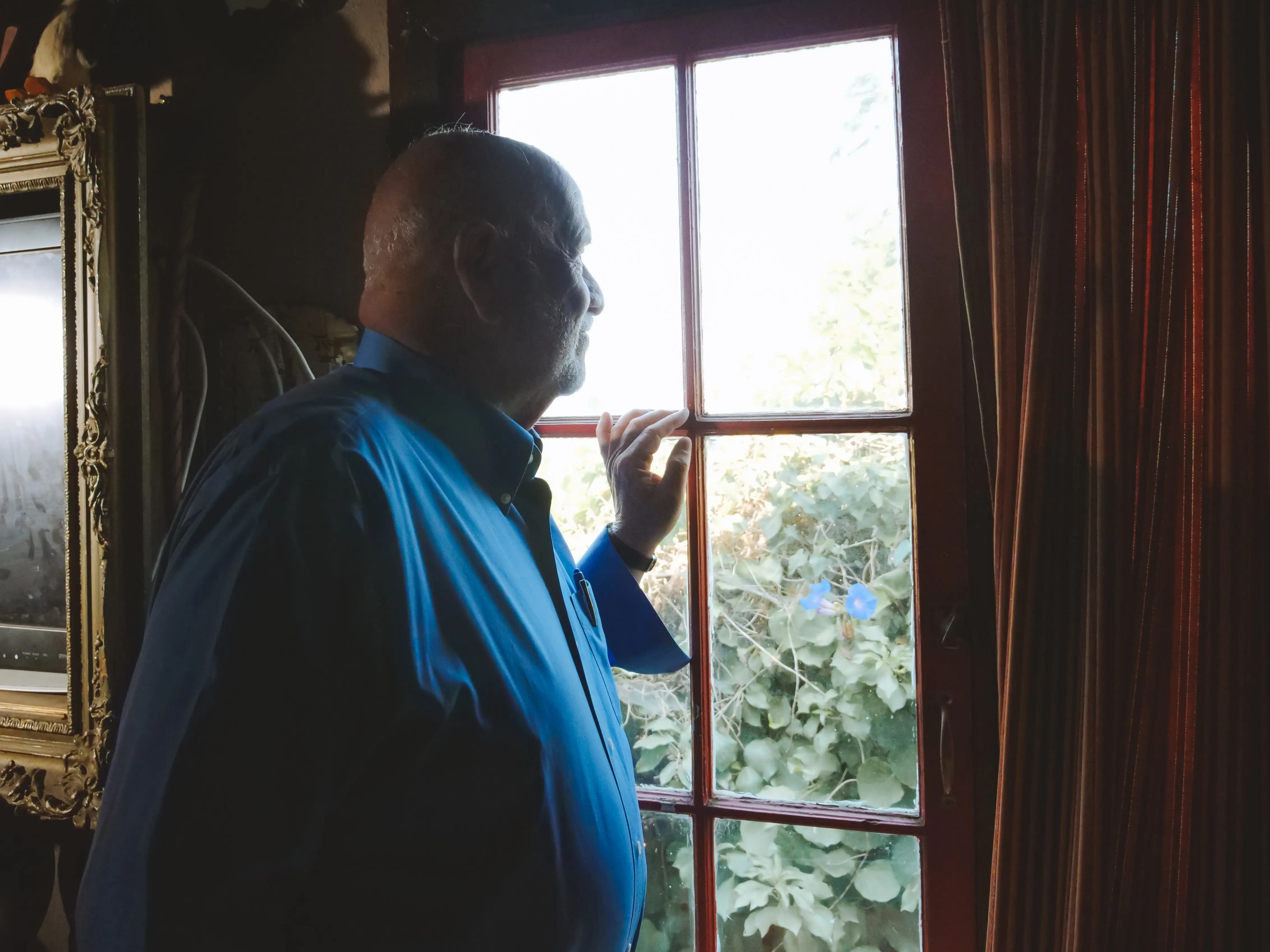 photo of man looking out window